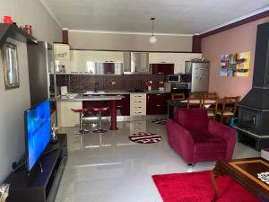 a living room with a kitchen and a dining room at Vila Kani in Krujë