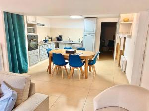 a kitchen and dining room with a table and chairs at L’appart classé 4* in Longeville-sur-Mer