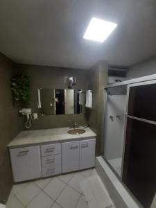 a bathroom with a sink and a shower at GARVEY PARK HOTEL in Brasilia +42 photos