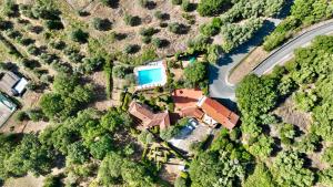 an aerial view of a house with a swimming pool at Madonna del Poggio B&B in Scarlino