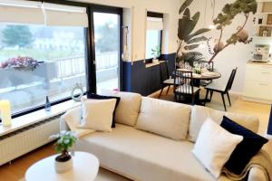 a living room with a couch and a large window at Rooftop Wohnung Kehl bei Strasbourg in Kehl am Rhein