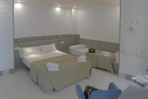 Postel nebo postele na pokoji v ubytování Hostal Gravina