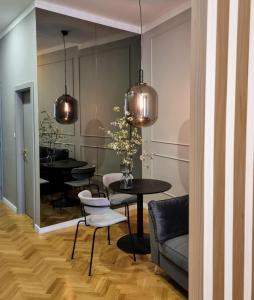 a dining room with a table and chairs and a mirror at MINT Boutique Studio Apartments in Zagreb