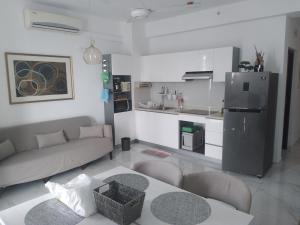 a living room with a couch and a kitchen at PL BEACH FRONT APARTMENT in Bopitiya
