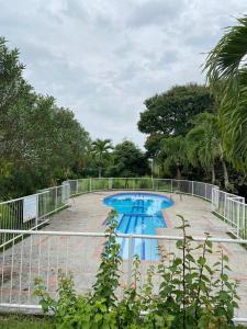 a swimming pool with a fence around it at Villa Zunilda in Rivera