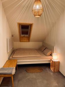 a bed in a tent with a window and a lamp at Ferienwohnung Balkonien in Wangen im Allgäu