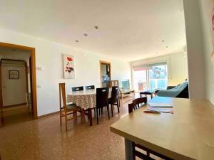 a living room with a table and chairs at Big Family Terrassa Parking and noise free in Terrassa