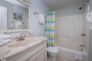 a bathroom with a sink and a toilet and a shower at Litchfield Beach & Golf Resort in Pawleys Island