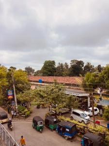 a group of cars parked in a parking lot at Railway Hostel in Matara