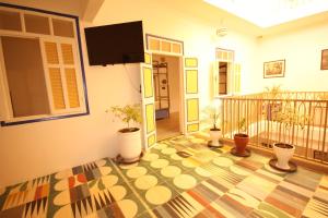 a living room with a colorful floor with potted plants at El Boussouni Hostel in Marrakesh