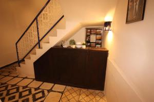 a hallway with a staircase with a counter and a stair case at El Boussouni Hostel in Marrakech