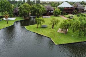 an island in the middle of a river with houses at 4 Fish Eagle Lodge in Sasolburg