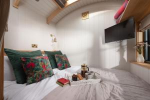 a bedroom with a bed with a tray of food on it at Willow, Devon Heaven Hideaways, Nr Exeter in Kenton