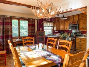 a kitchen with a wooden table and a dining room at Mountainside Cabin / peaceful / near hiking trails in Cascade-Chipita Park