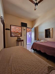 a bedroom with a large bed and a window at Canto do Rio Pousada in Vargem Bonita