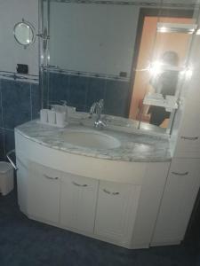 een badkamer met een wastafel en een spiegel bij B&B - Antonietta & Friends in Mercato San Severino