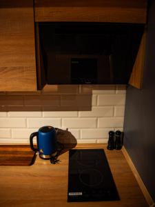 a blue coffee mug sitting on the floor in a kitchen at Котляревського апартамент з садом in Lviv