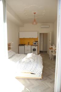 a bedroom with a bed and a kitchen with a table at Princess Apartment 2 - Turin - Like at Your Home in Turin