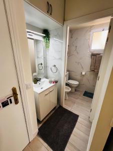 a small bathroom with a sink and a toilet at Apartamento perla marina in Morro del Jable