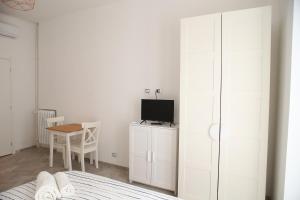 a bedroom with a bed and a desk with a television at Princess Apartment 2 - Turin - Like at Your Home in Turin