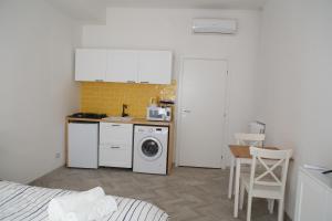 a kitchen with a washer and dryer in a room at Princess Apartment 2 - Turin - Like at Your Home in Turin
