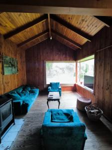 sala de estar con sofás azules y TV en Nómada Austral pieza 2, en Puerto Montt