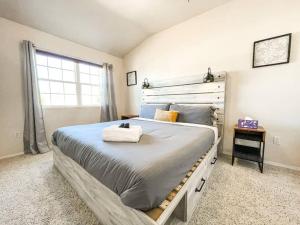 a bedroom with a large bed and a window at The Mountain Lake Manor [Minutes from USAFA] in Monument