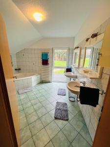 a large bathroom with two sinks and a tub at Tanjas Haus am Mondsee in Innerschwand