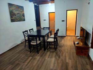 a dining room with a black table and chairs at Apartments Alexandra in Opanets