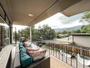 a porch with a couch on a balcony at Mountain View Apartment / stylish / cozy / central in Colorado Springs