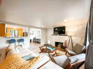 a living room with a couch and a fireplace at Mountain View Apartment / stylish / cozy / central in Colorado Springs