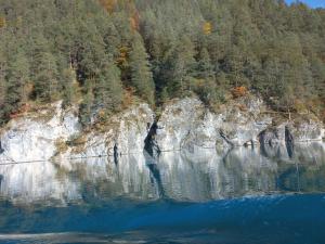 a reflection of a mountain in the water at Haus Birke in Weissensee