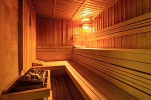 an empty wooden sauna with a light in it at Mercure Gdańsk Posejdon in Gdańsk