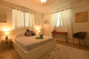 a bedroom with a bed with a teddy bear on it at One Bedroom Apartment, Private pool, huge yard in Anasco
