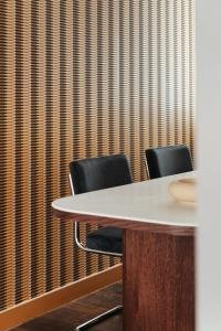 a meeting room with two chairs and a table at Edgar Suites Lille - Faidherbe in Lille