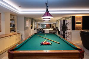 a pool table in a living room with a bill at Vancouver Golf Villa - Private Oasis in Vancouver
