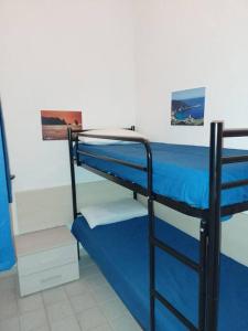 Ένα ή περισσότερα κρεβάτια σε δωμάτιο στο Pesciolino Bianco