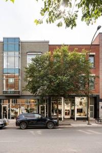 a black car parked in front of a building at MileEnd - Huge Bright & Modern Loft Suite - KingBed in Montréal