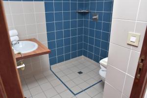 a bathroom with a sink and a toilet at HOTEL LE CHANNEL in Le Marin