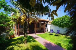 a house with two blue chairs in a yard at Avdira Seaside House in Ávdhira