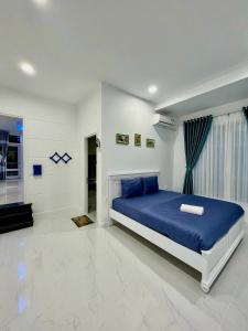 Ấp Phú Tịnh (2)にあるVilla Near the Beach 5 Bedrooms pe24の白い部屋に青いベッドが備わるベッドルーム1室