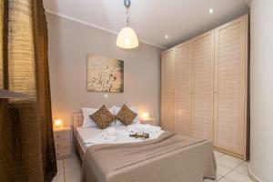 a bedroom with a bed with towels on it at Cristina Apartment 2 in Neos Marmaras