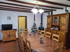 a dining room with a table and a christmas tree at Maison de Campagne Les Oyats in Quend