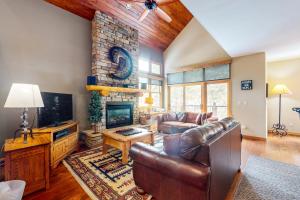 a living room with a leather couch and a fireplace at Northstar Townhome Unit 1968 in Keystone