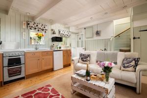 a living room with a couch and a table at Portloe Cottage Padstow in Padstow