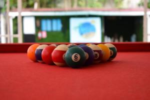 a row of billiard balls on a pool table at Hostal Loco Coco Loco in Panama City