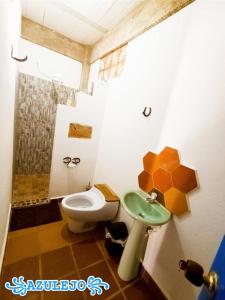 a bathroom with a toilet and a sink at AZULEJO in Jericó