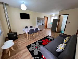 een woonkamer met een bank en een tafel bij Cabañas Ruta Lacustre in Licán Ray