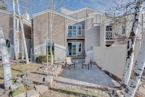 a house with a fence in front of it at Loveland Townhome Walkable to Lake and Park! in Loveland