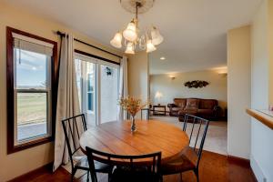 a dining room with a wooden table and chairs at Loveland Townhome Walkable to Lake and Park! in Loveland